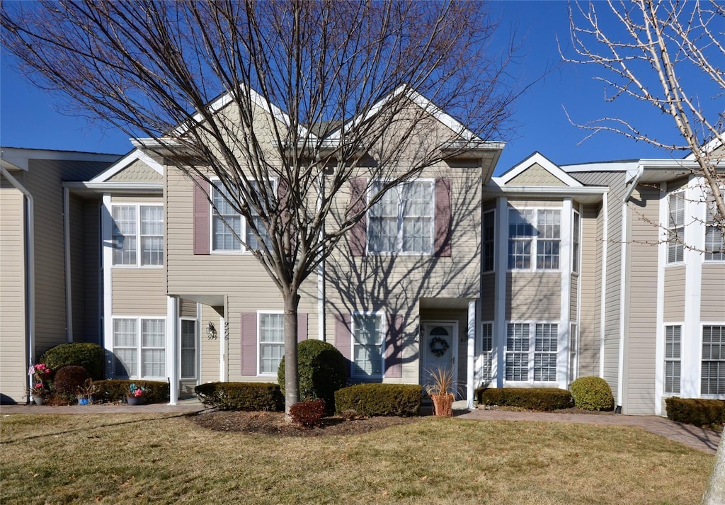 multi unit property featuring a front lawn