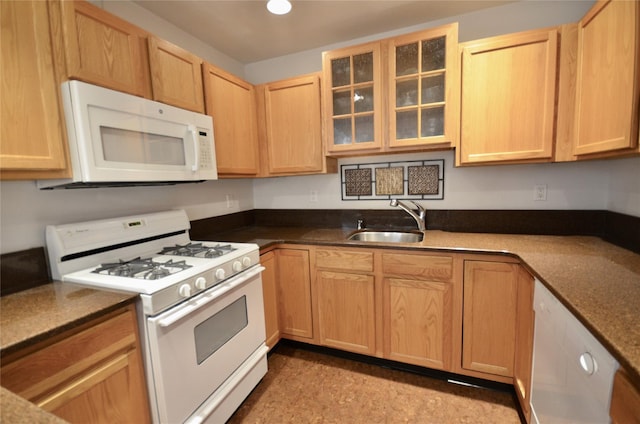 kitchen featuring sink, white appliances, and light brown cabinets