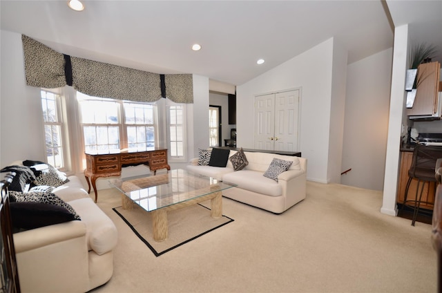 carpeted living room with vaulted ceiling