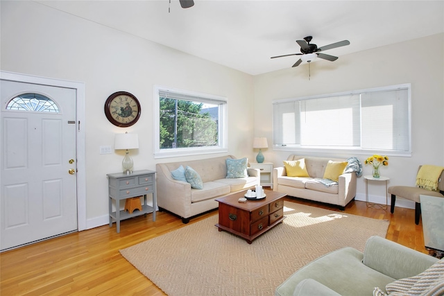 living room with ceiling fan and light wood-type flooring