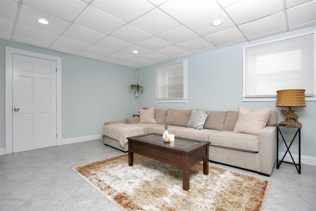 tiled living room with a drop ceiling