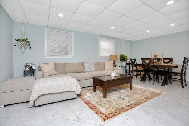 tiled living room featuring a drop ceiling