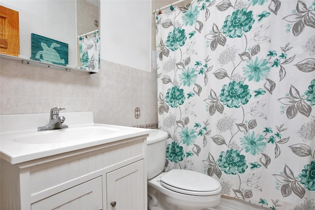 bathroom featuring a shower with curtain, vanity, toilet, and tile walls