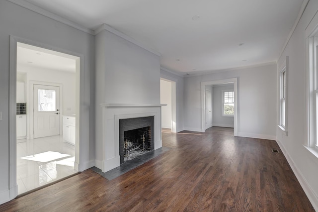 unfurnished living room with ornamental molding and dark hardwood / wood-style floors