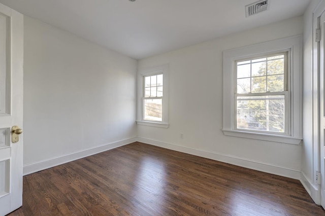 spare room with dark hardwood / wood-style flooring