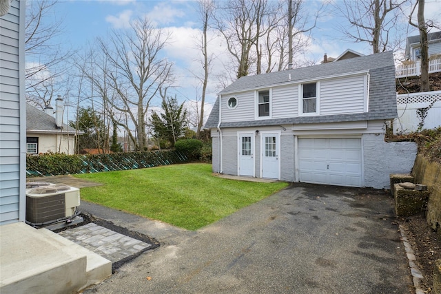 exterior space with an attached garage, driveway, fence, and cooling unit