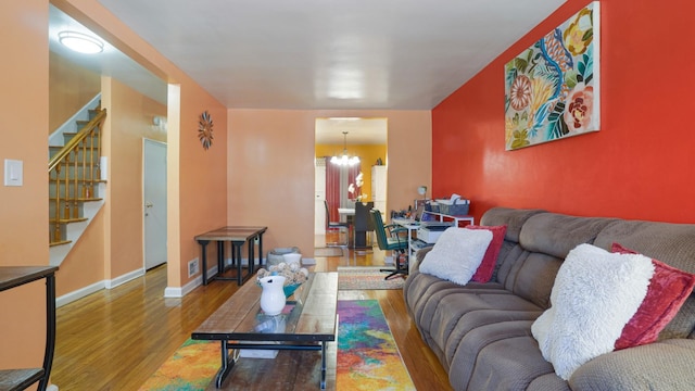 living room with a notable chandelier and hardwood / wood-style flooring