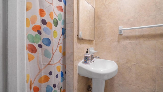 bathroom with tile walls and walk in shower