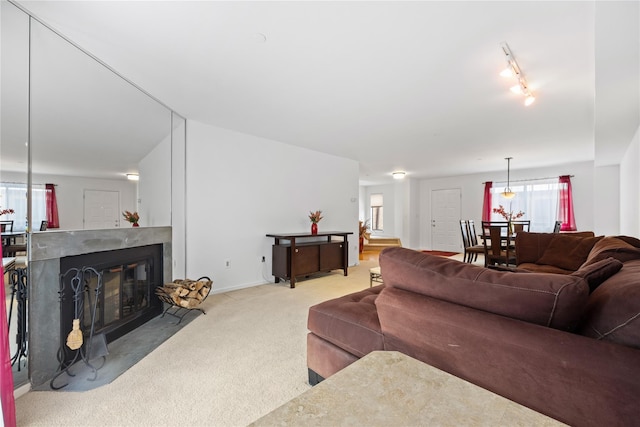 carpeted living room with track lighting