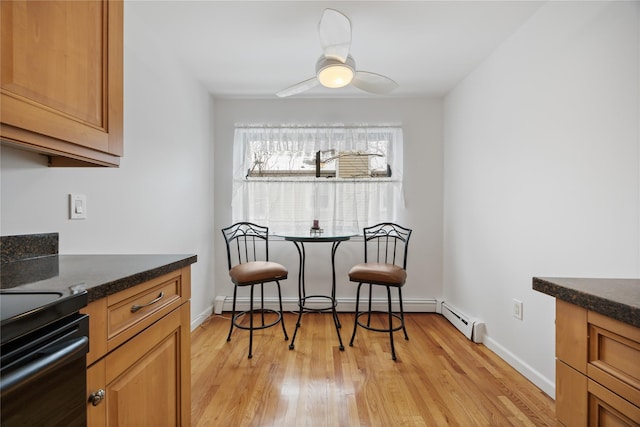 dining space featuring light hardwood / wood-style floors, ceiling fan, and baseboard heating