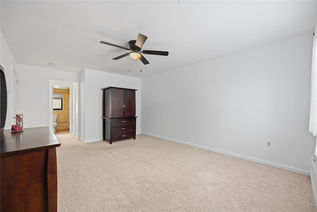 unfurnished bedroom with light colored carpet, ceiling fan, and ensuite bathroom