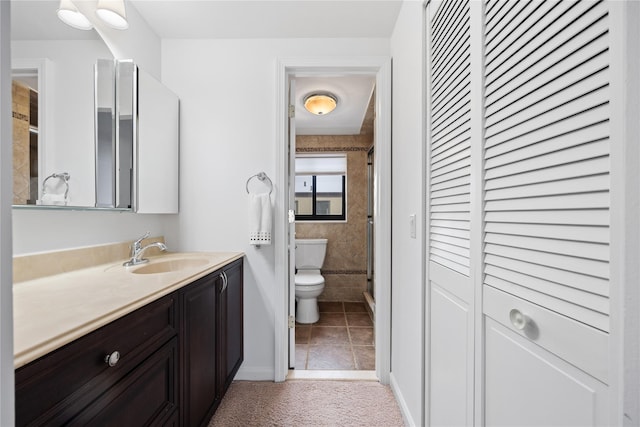 bathroom with vanity, tile patterned floors, and toilet