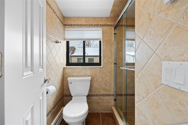 bathroom with a shower with shower door, tile walls, baseboard heating, toilet, and french doors