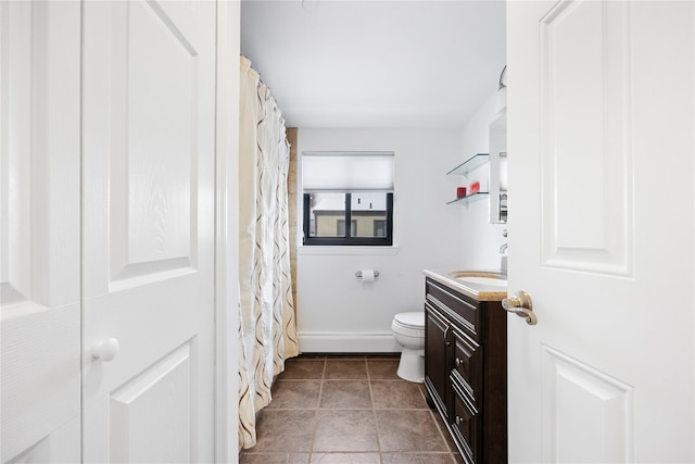 bathroom with vanity, tile patterned flooring, and toilet