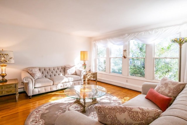 living room with baseboard heating and wood-type flooring