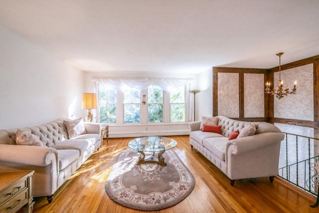 living room featuring a chandelier and light hardwood / wood-style floors