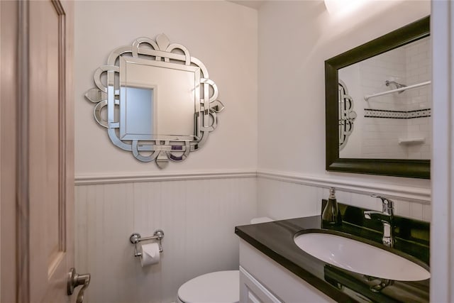 bathroom with vanity, toilet, and water heater