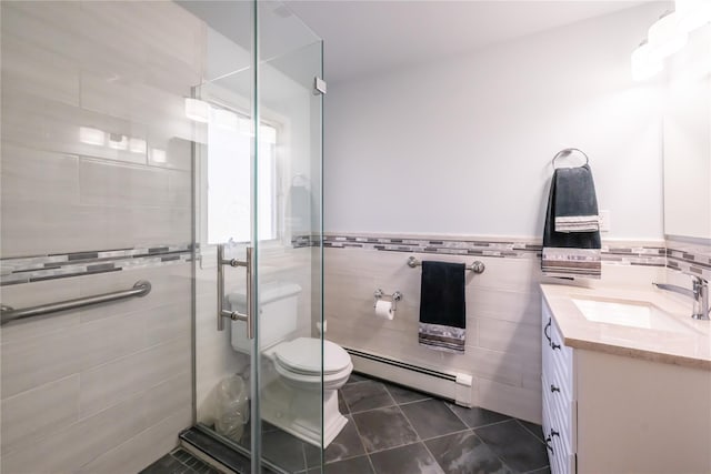 bathroom featuring tile walls, vanity, a baseboard radiator, tile patterned floors, and toilet