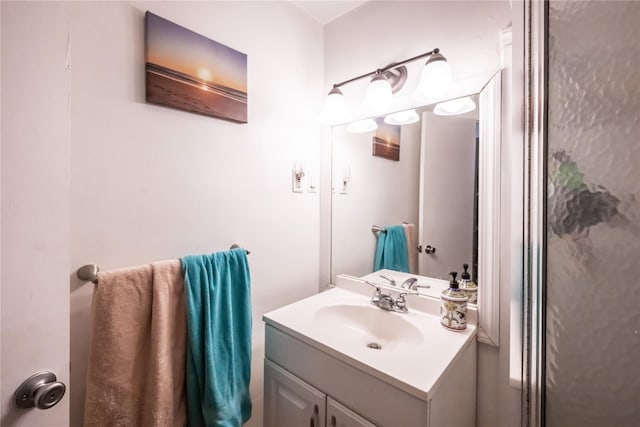 bathroom with vanity and a shower with shower door