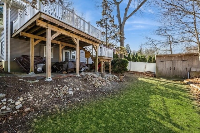 view of yard with a wooden deck and a storage unit