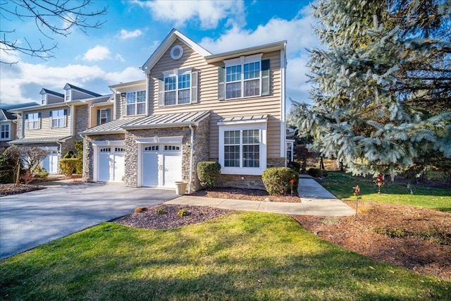 view of front of property with a garage and a front lawn