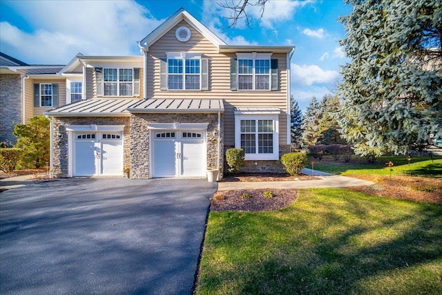 view of front of property with a garage and a front lawn