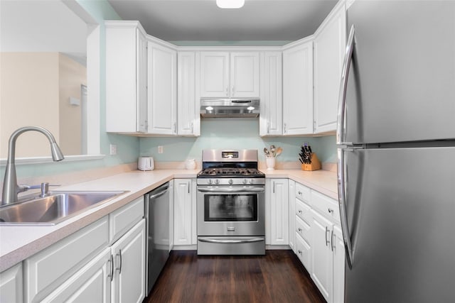 kitchen with white cabinetry, appliances with stainless steel finishes, dark hardwood / wood-style floors, and sink