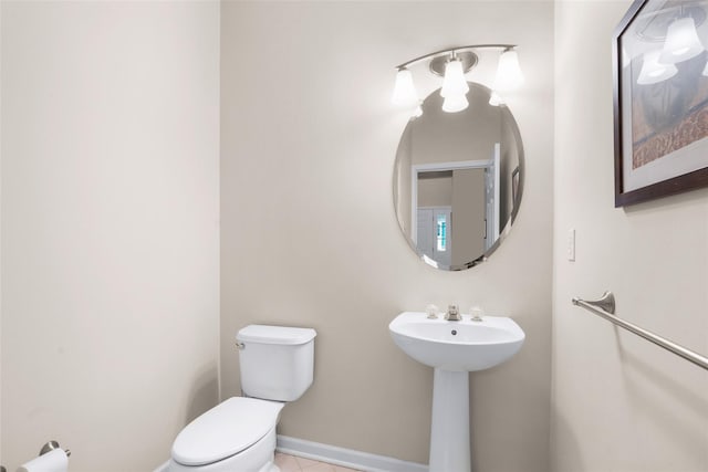 bathroom with sink, tile patterned floors, and toilet