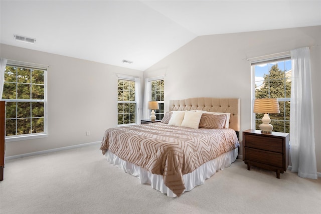 bedroom featuring lofted ceiling and light carpet