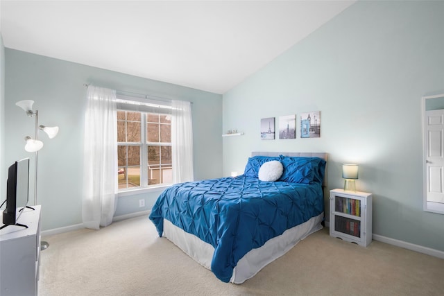 carpeted bedroom featuring lofted ceiling