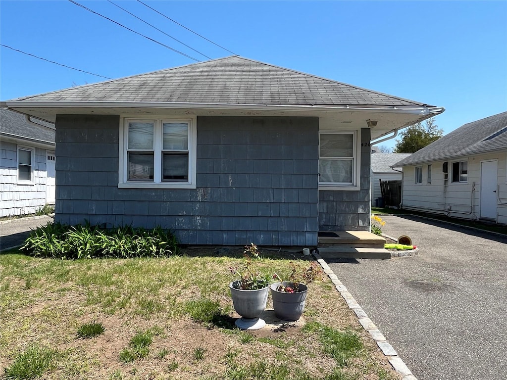 42 Firwood Rd, Port Washington, NY 11050 - view of side of home with roof with shingles