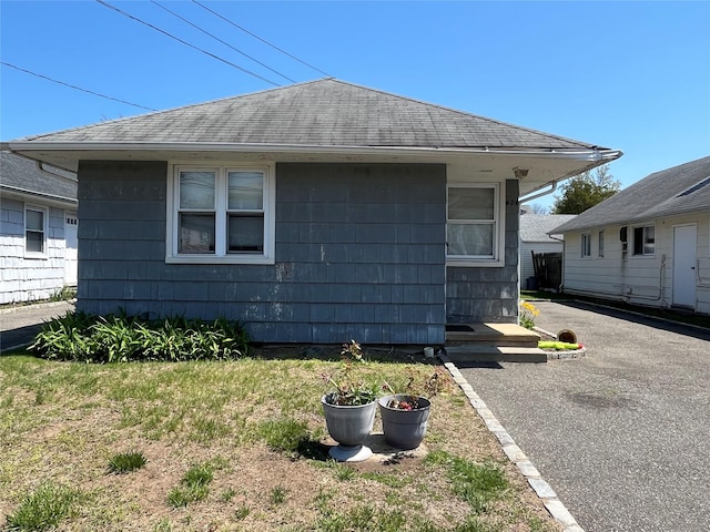 42 Firwood Rd, Port Washington, NY 11050 - view of side of home with roof with shingles