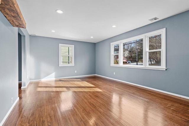 unfurnished room with wood-type flooring