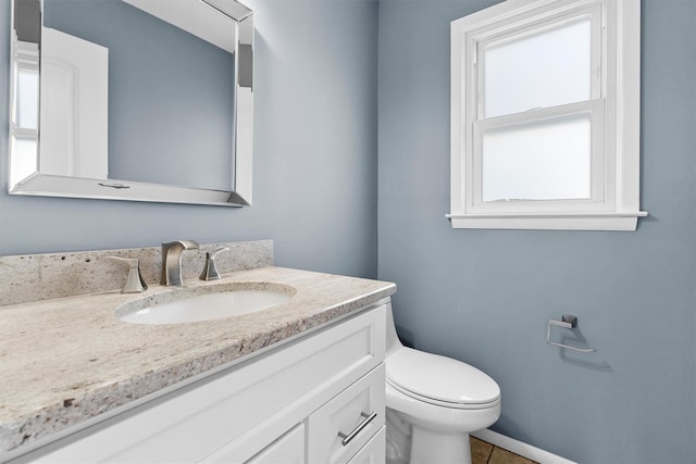 bathroom with vanity, tile patterned floors, and toilet