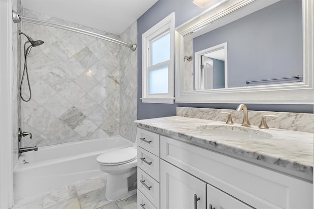 full bathroom with tiled shower / bath combo, vanity, and toilet