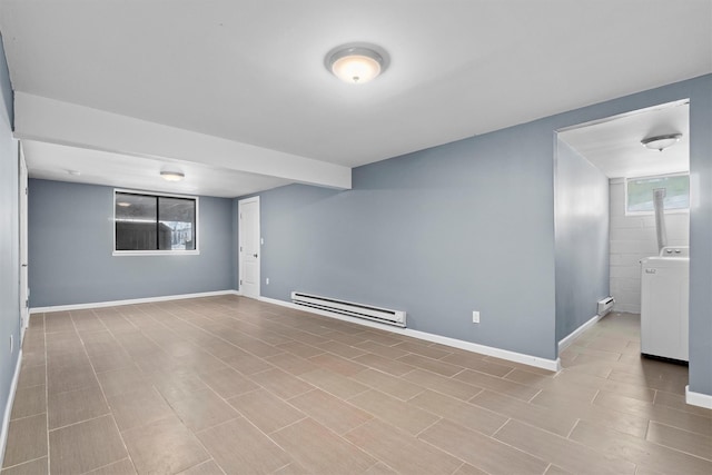 basement with baseboard heating and washer / clothes dryer