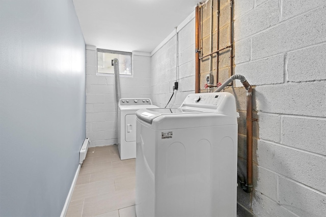 laundry area featuring washer and dryer, light tile patterned floors, and baseboard heating