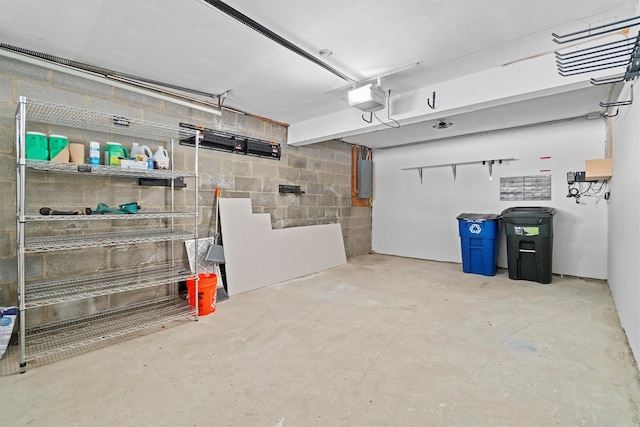 garage with a garage door opener and electric panel