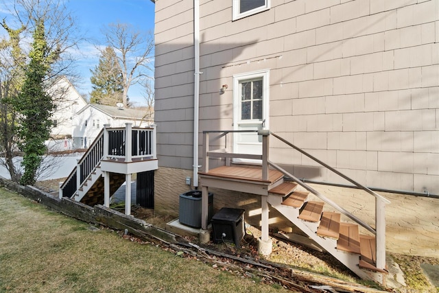 view of property exterior featuring a lawn and central air condition unit