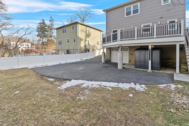 back of property with a garage