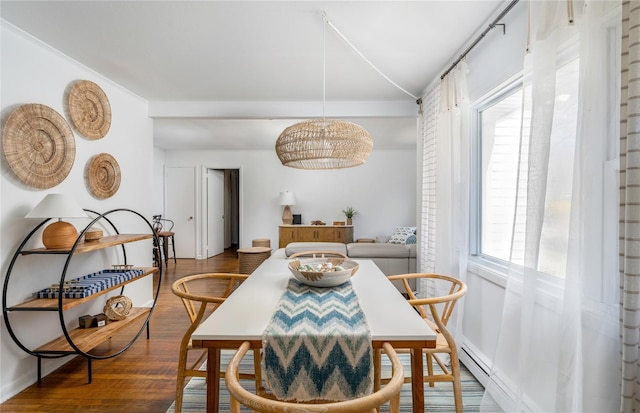 dining space with wood-type flooring and vaulted ceiling