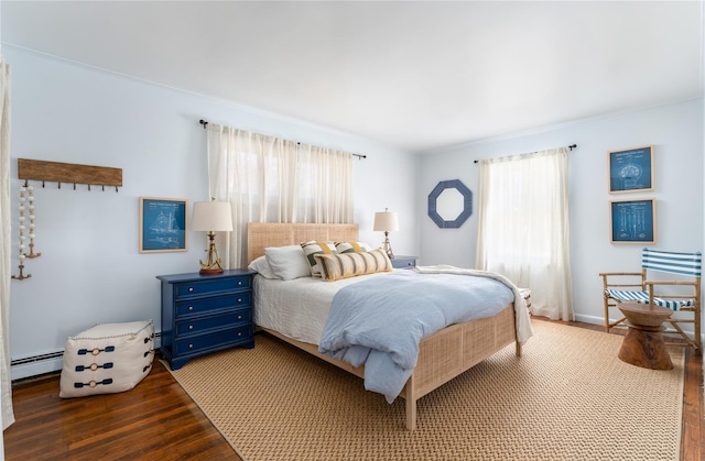 bedroom with hardwood / wood-style flooring and a baseboard radiator