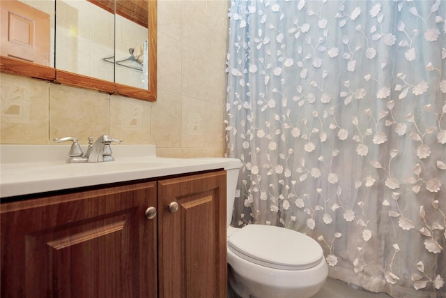 bathroom featuring tile walls, vanity, and toilet