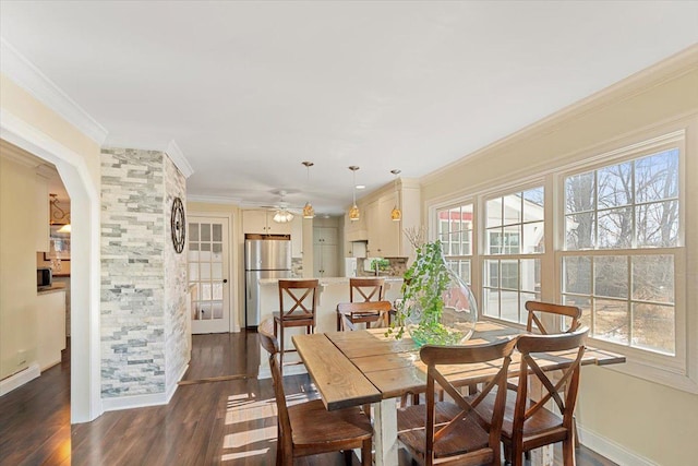 dining area with a wealth of natural light, dark wood-style flooring, and crown molding