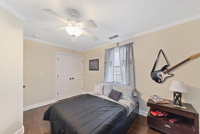 bedroom with crown molding, visible vents, ceiling fan, wood finished floors, and baseboards