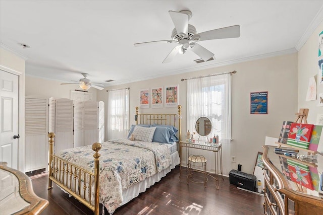 bedroom with ornamental molding, dark wood-style flooring, visible vents, and ceiling fan