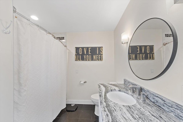 bathroom with vanity, tile patterned flooring, toilet, and baseboards