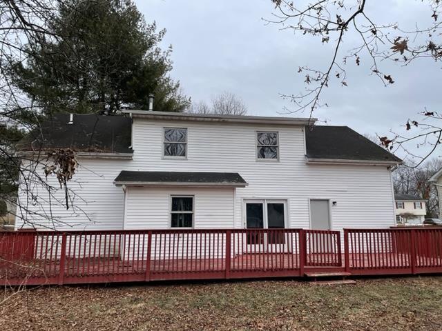 back of property with a wooden deck