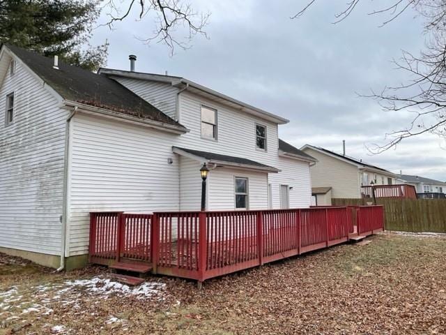 rear view of house featuring a wooden deck