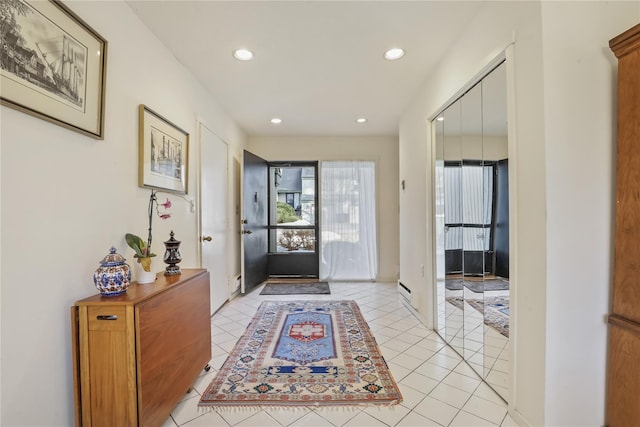 foyer entrance featuring a baseboard radiator and light tile patterned floors